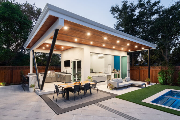stone patio with table and outdoor lights