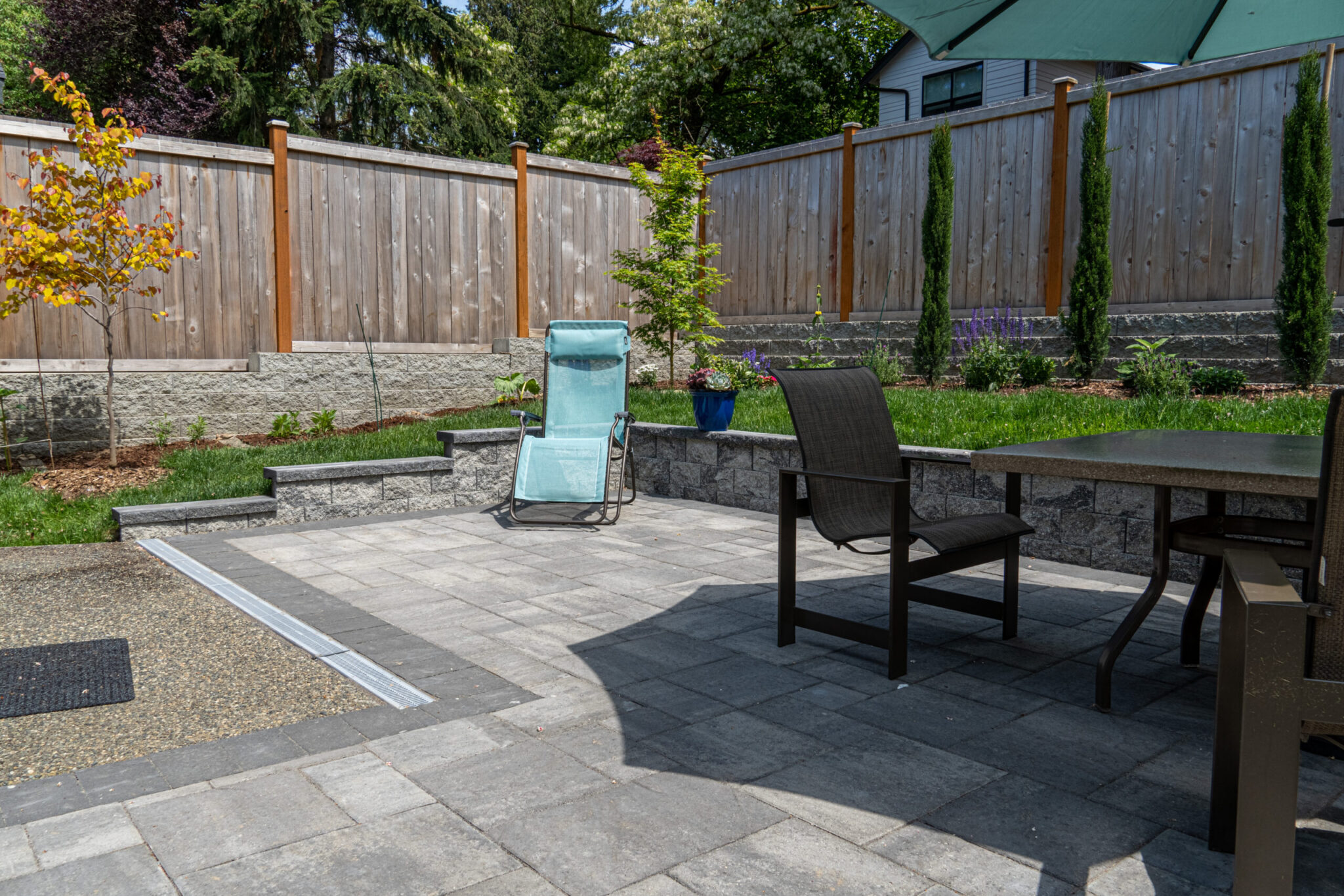 backyard stone patio with chairs