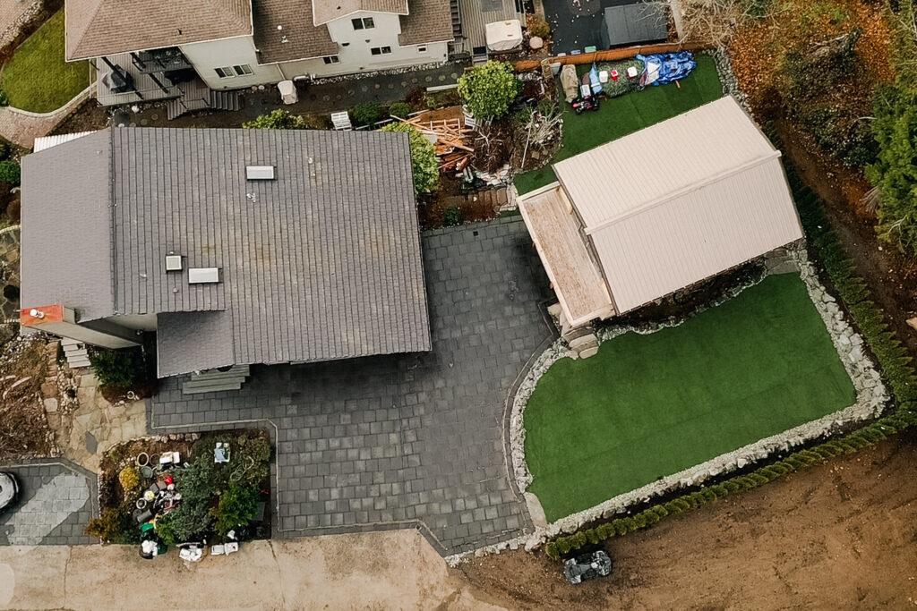 Completed artificial turf and paver project by Provenance Outdoor Living