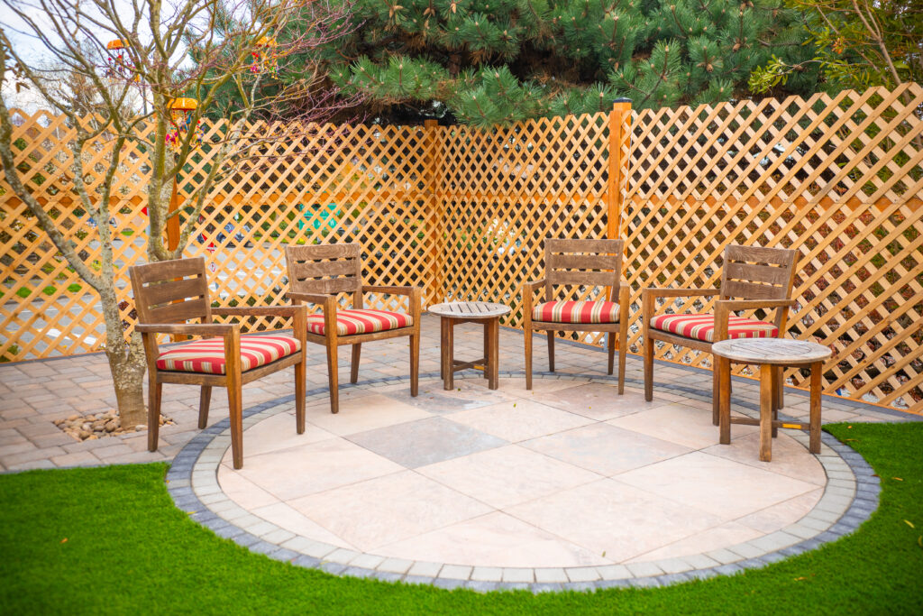 Artificial turf blended into a full outdoor living design with a patio